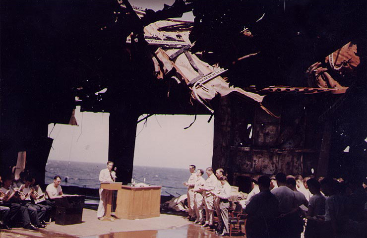 Church service on carrier Franklin's ruined hangar deck, in or near New York Harbor, New York, United States, circa 28 Apr 1945