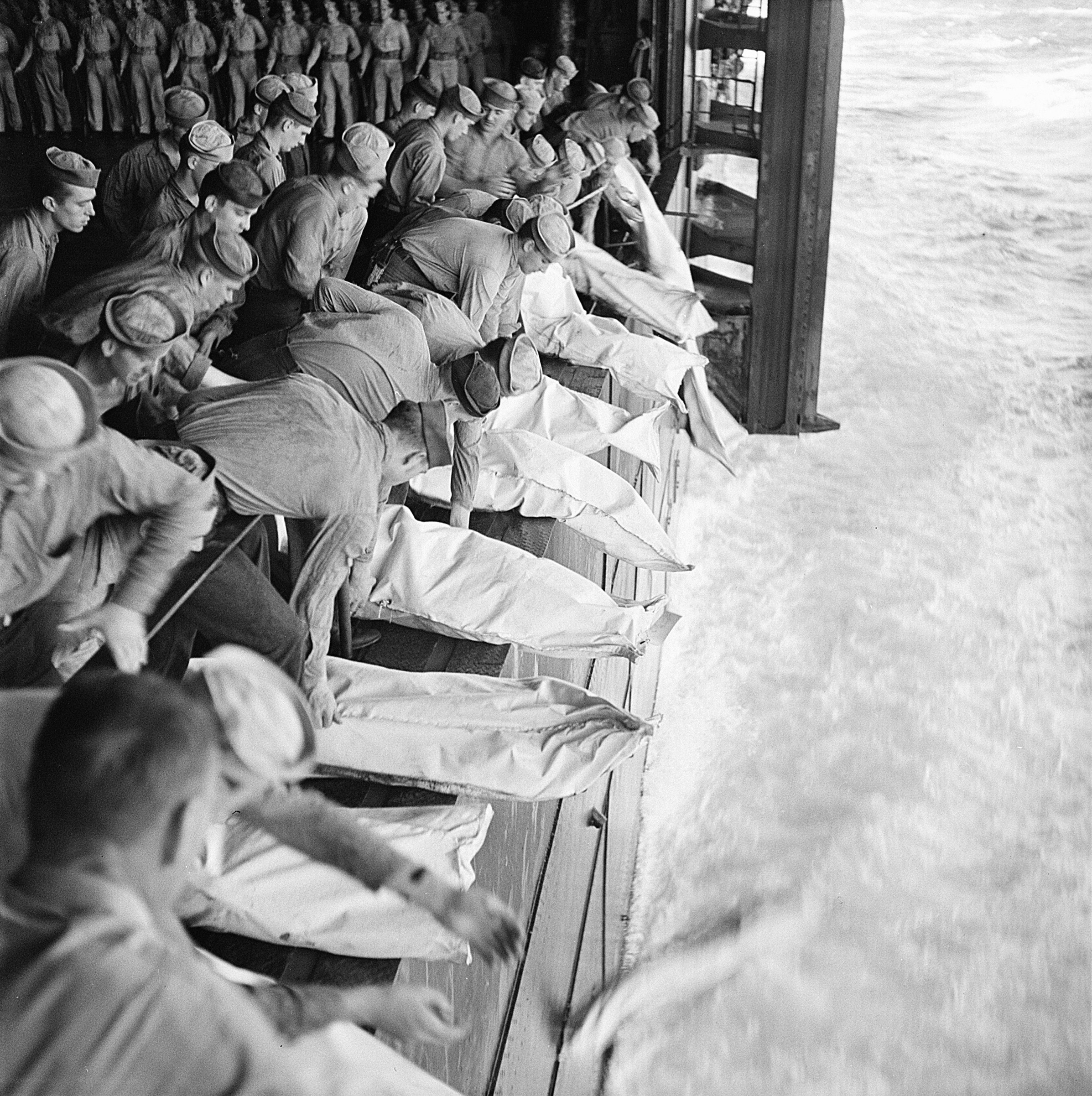 A burial party assembled on Intrepid's hangar deck in the Philippine Sea the day following the special attack of 25 Nov 1944, photo 5 of 5