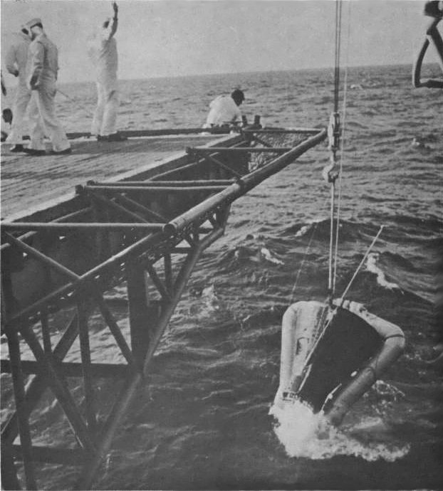 Gemini 3 spacecraft being hoisted aboard USS Intrepid during recovery, in the Atlantic Ocean north of the Dominican Republic, 23 Mar 1965, photo 2 of 2