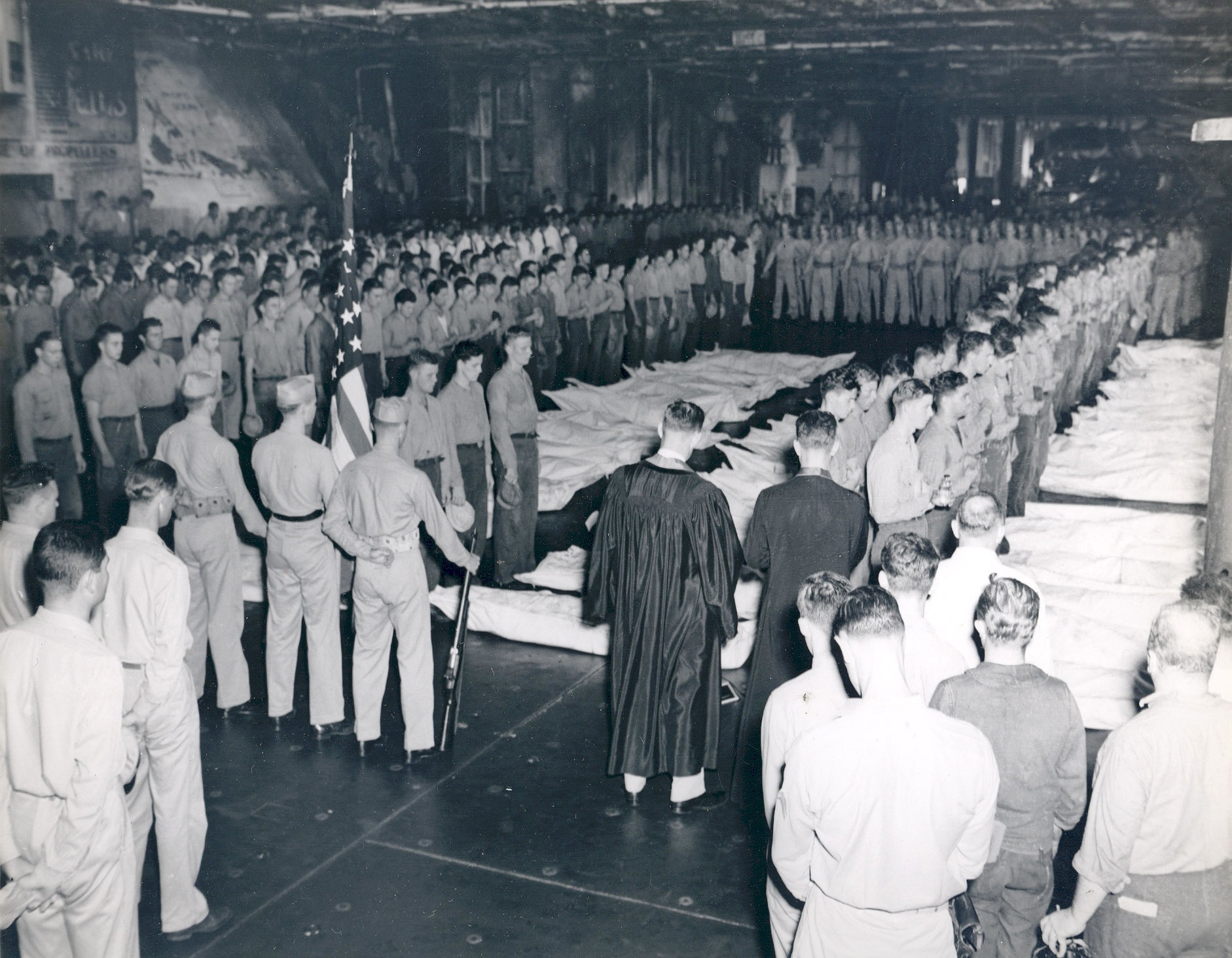 A burial party assembled on Intrepid's hangar deck in the Philippine Sea the day following the special attack of 25 Nov 1944, photo 2 of 5
