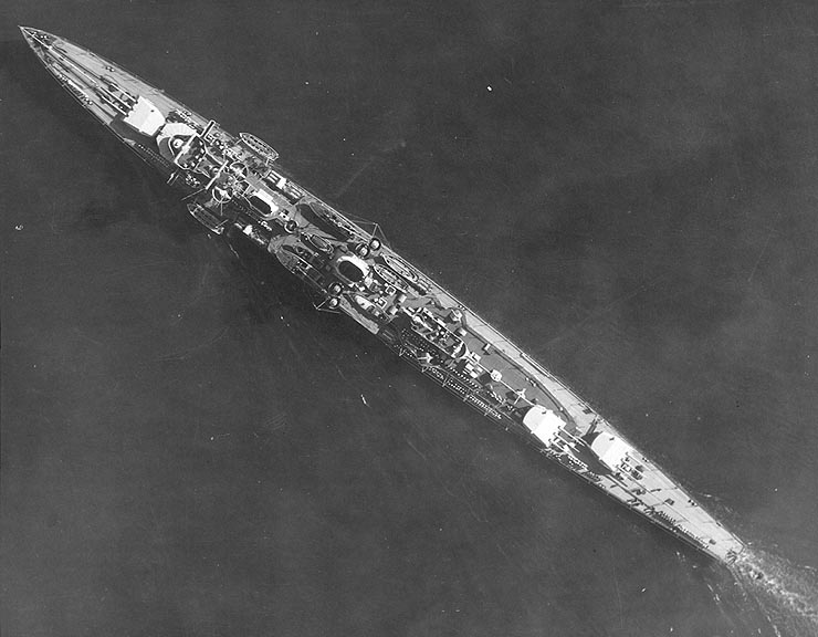Aerial view of German light cruiser Karlsruhe underway off San Diego, California, United States, 27 Mar 1934; note off-centerline positioning of turrets