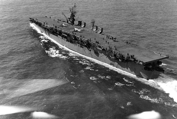 USS Langley underway off Cape Henry, Virginia, United States, 6 Oct 1943; note SNJ aircraft on flight deck
