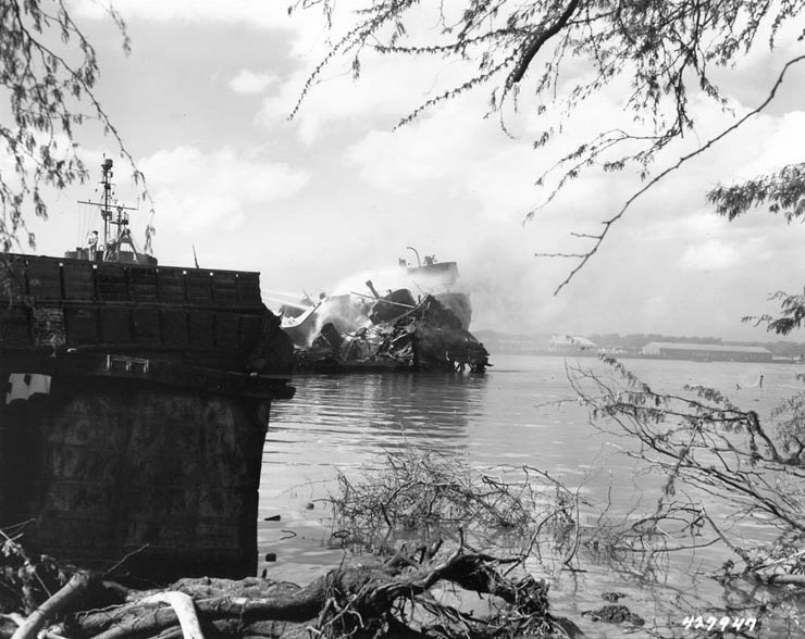 US Coast Guard vessel Woodbine fighting a fire on the stern of a destroyed LST which exploded the previous day, West Loch, Pearl Harbor, 22 May 1944