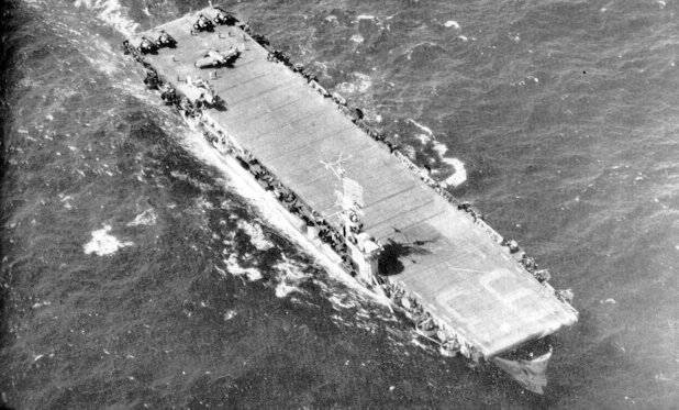 Aerial view of USS Makin Island off Okinawa, Japan, 1945; note FM-2 Wildcat and TBM Avenger aircraft on the flight deck