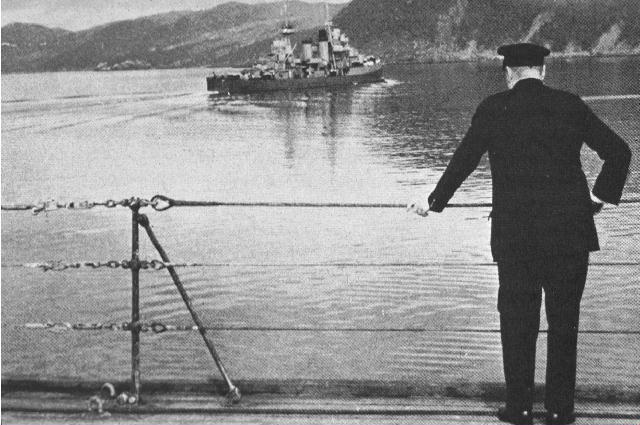 Winston Churchill on the deck of HMS Prince of Wales watching the USS McDougal as the ship transported Roosevelt back to the USS Augusta, 10 Aug 1941