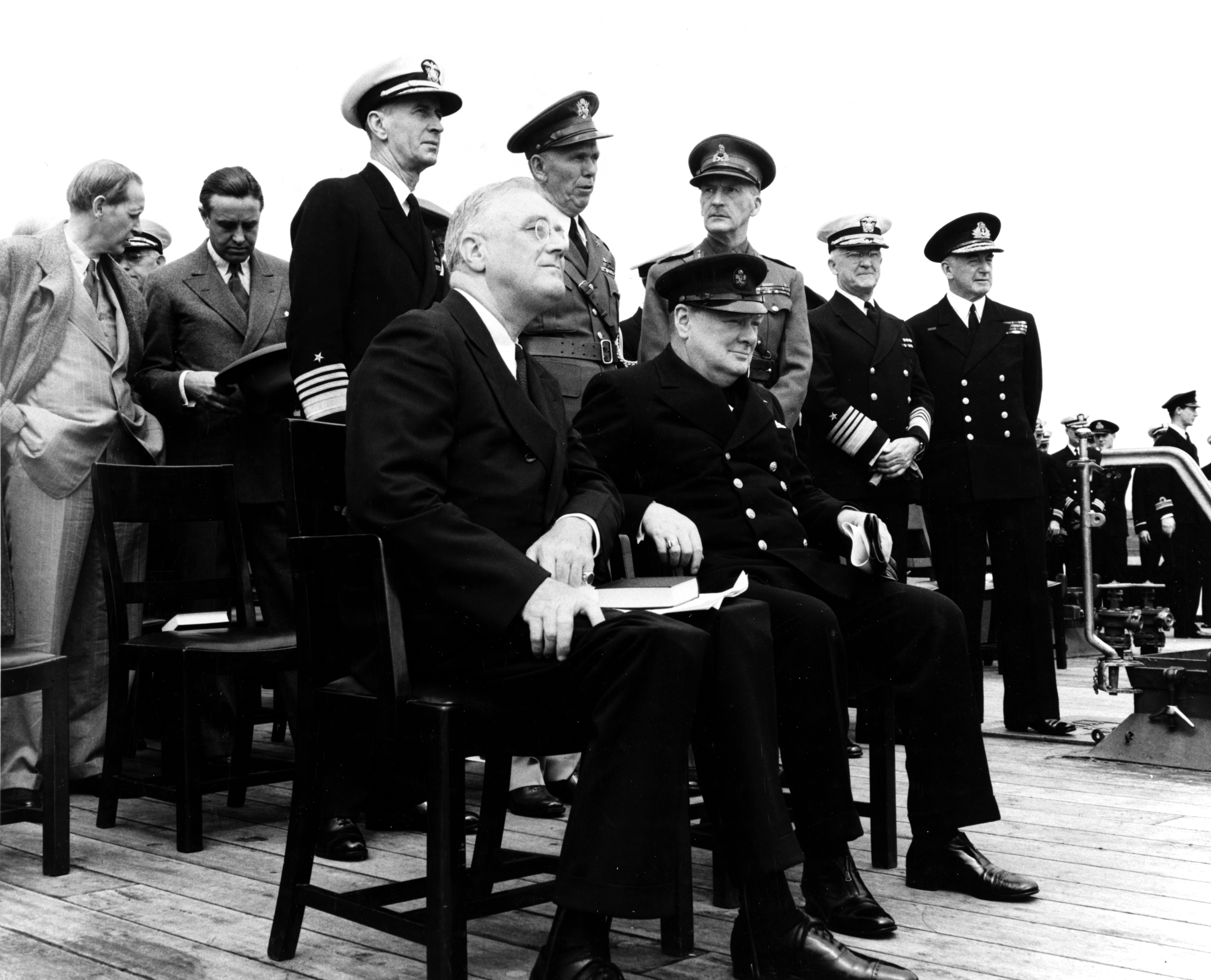 Roosevelt and Churchill at the Atlantic Charter Conference, Placentia Bay, Newfoundland, 10-12 Aug 1941, photo 1 of 2; Hopkins, Harriman, King, Marshall, Dill, Stark, and Pound behind them