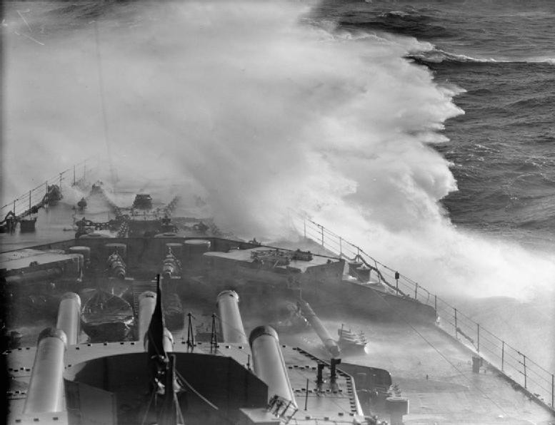View of the bow of HMS Rodney while underway in heavy seas, date unknown