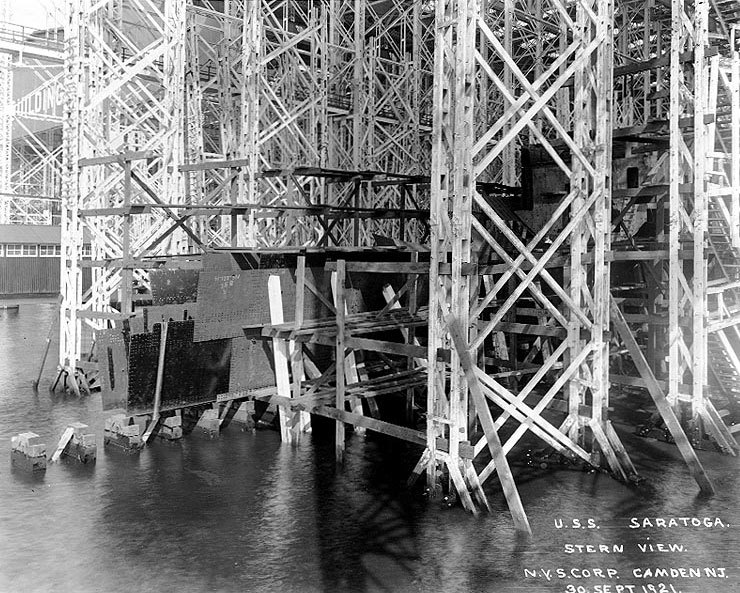 Saratoga's stern plates while under construction, seen from starboard, extending out over the Delaware River, Camden, New Jersey, United States, 30 Sep 1921