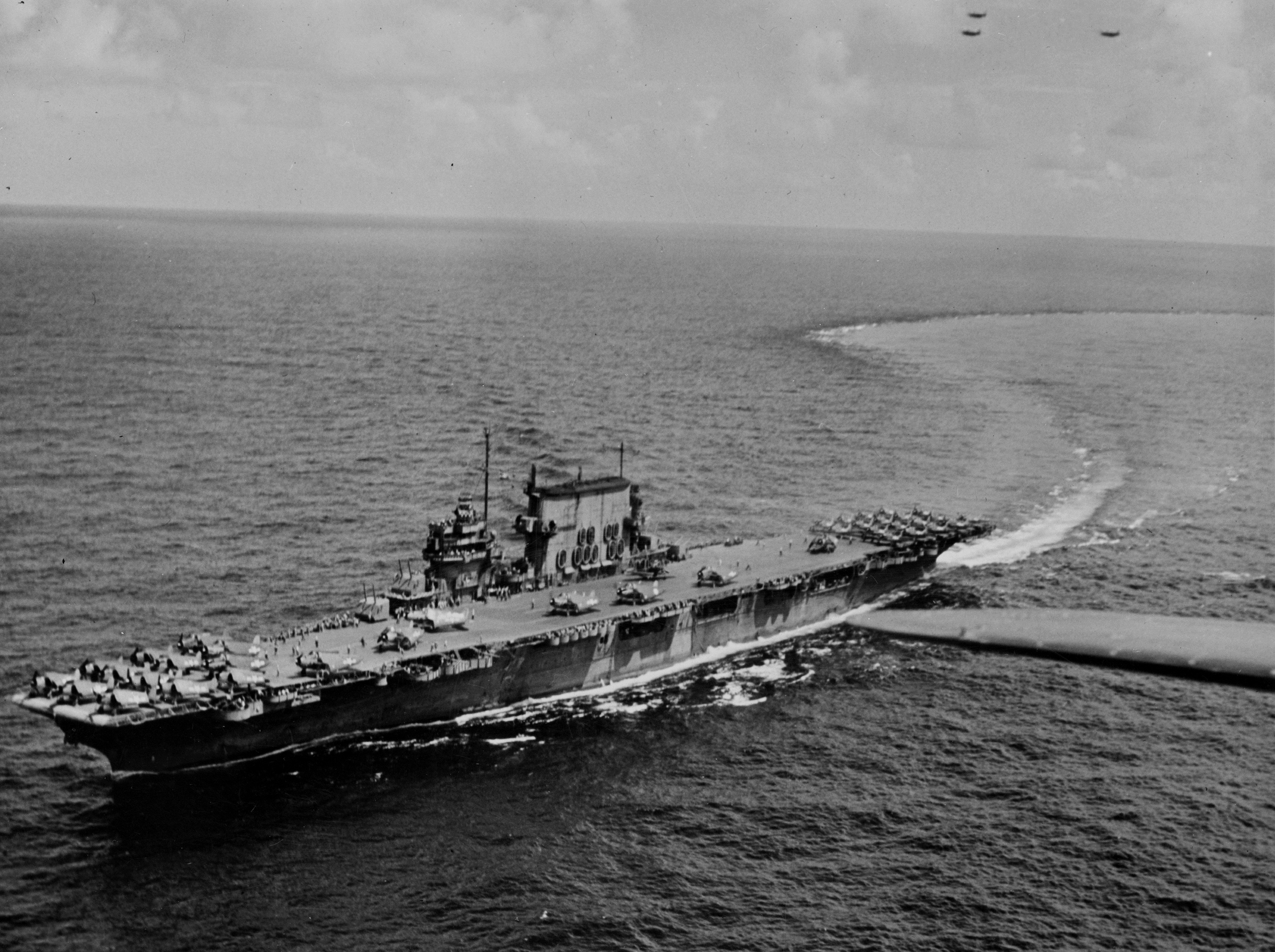USS Saratoga underway with SBD Dauntless, F6F Hellcat, and TBF Avenger aircraft on her flight deck, 1943-1944