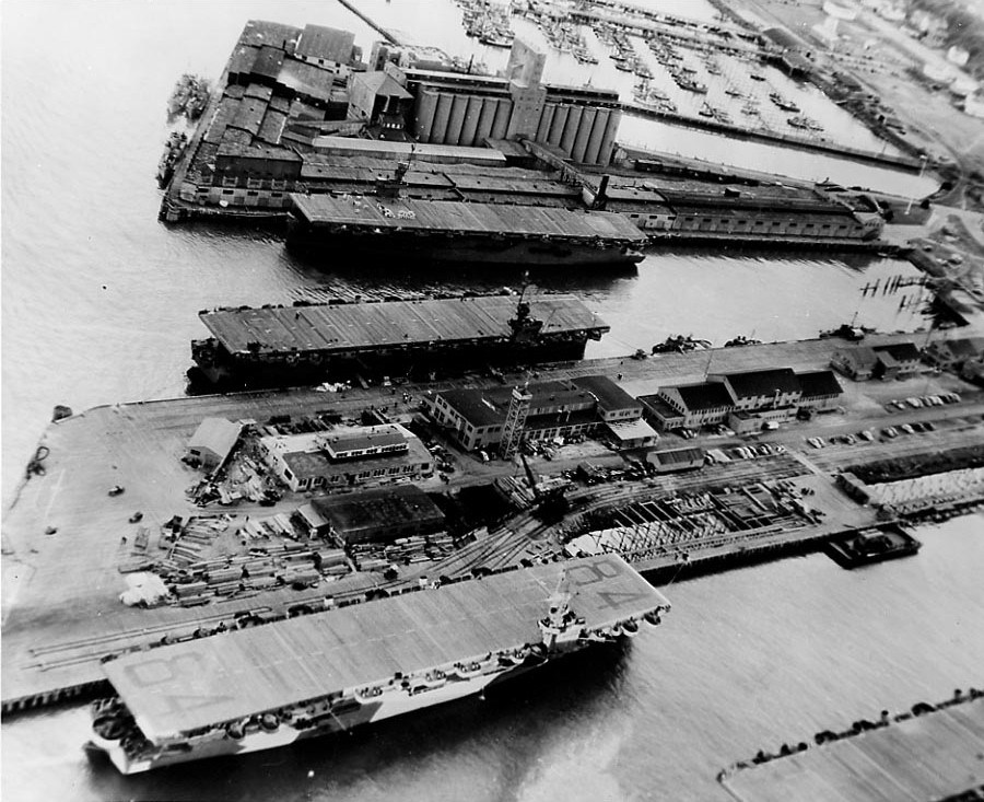 USS Shamrock Bay (bottom of photograph) with two other escort carriers, Astoria, Oregon, United States, 6 Apr 1944; photo taken by an aircraft from USS Shipley Bay