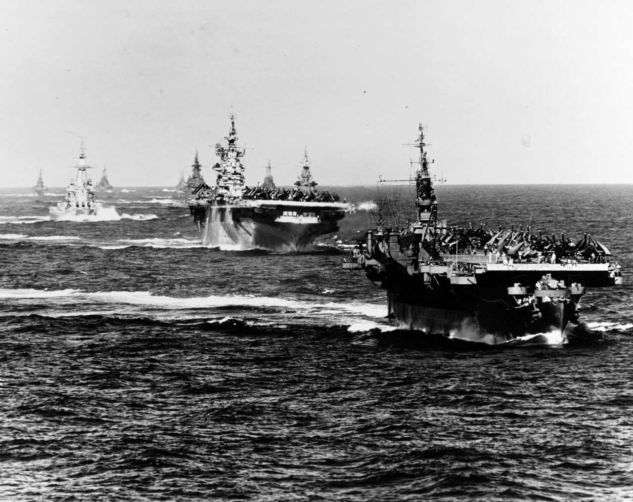 US Navy Task Group 38.3 entering Ulithi anchorage in a column following strikes in Philippine Islands, 24 Dec 1944, photo 4 of 7