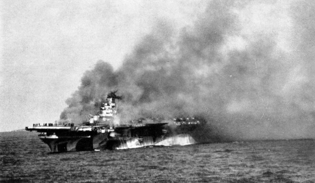 USS Ticonderoga burning after being hit by two special attack aircraft, 125 miles east-southeast of Taiwan, 21 Jan 1945