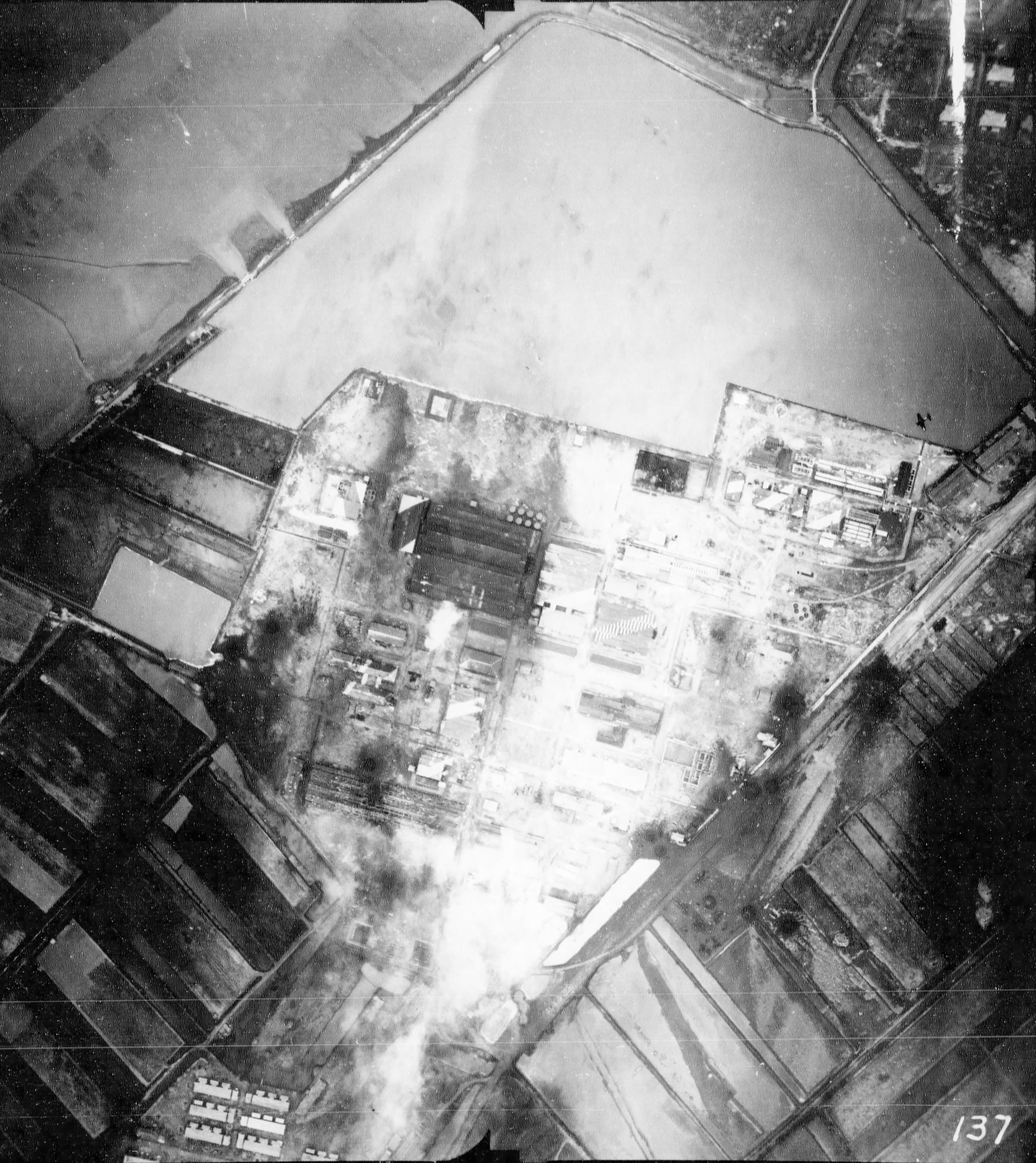 Kaneka Soda Company chemical plant under attack by Air Group 80 aircraft from USS Ticonderoga, Tainan, Taiwan, 15 Jan 1945, photo 1 of 2