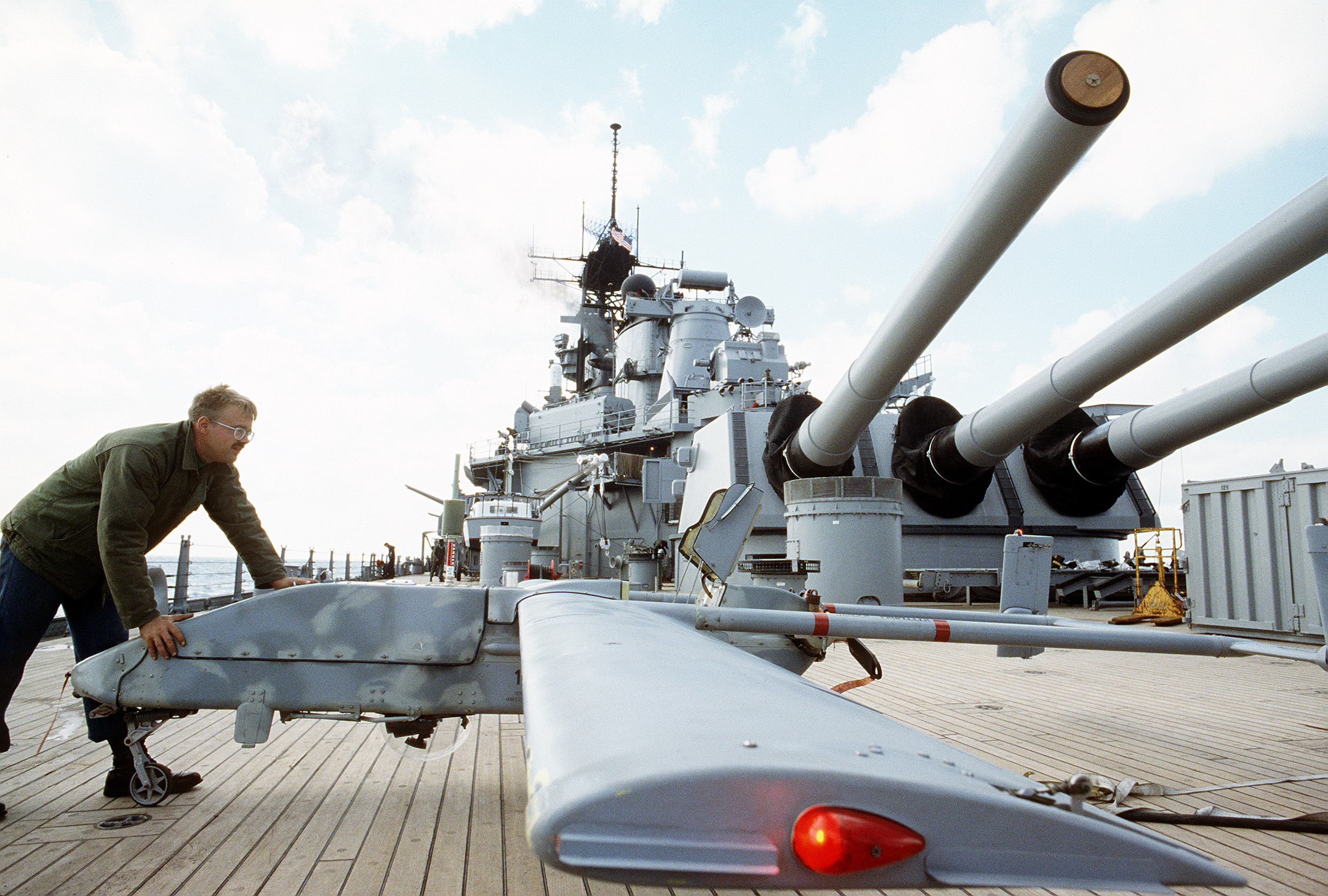 US Navy Aviation Electronics Technician 2nd Class Mike Moulding moving a Pioneer remotely piloted vehicle on the fantail of USS Wisconsin during Operation Desert Shield, 8 Aug 1991