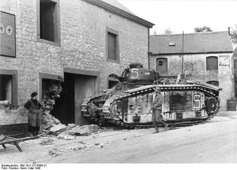 A Belgian civilian and a German soldier looking at an abandoned French Char B1 heavy tank, Ermeton-sur-Biert, Belgium, mid-May 1940