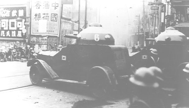 Japanese Navy Crossley armored cars fighting at the intersection of North Szechuen Road and Kewkong Road (now Sichuan North Road and Qiujiang Road), near the old Isis Theater, Shanghai, China, Jan 1932