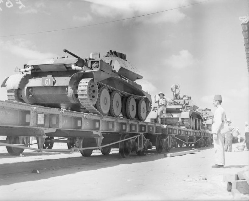 British Cruiser Mk IV tanks being loaded onto railway trucks at an Egyptian quayside after being unloaded from ships, 5 Oct 1940