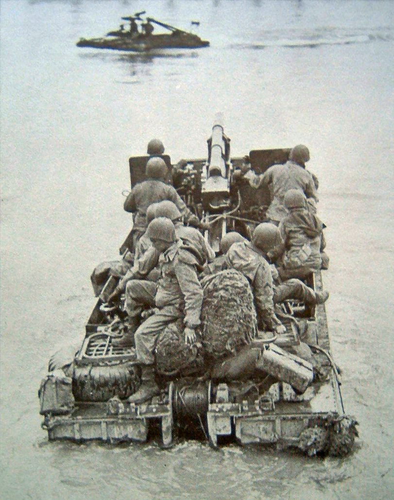 Loaded with US troops and a field artillery piece, a DUKW heading for shore, date unknown