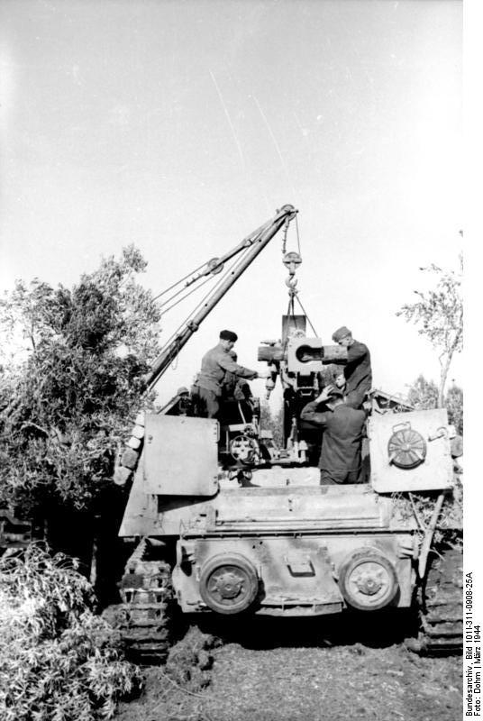 A camouflaged crane replacing the PaK 43 gun of a German Hornisse/Nashorn tank destroyer, Italy, Mar 1944