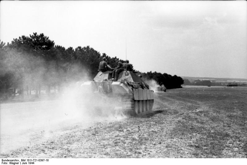 German Jagdpanther tank destroyer traveling across a field in France during the Allied invasion, Jun 1944