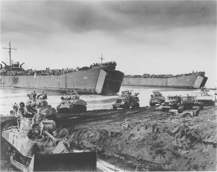 M4 Sherman tanks being unloaded from USCG-manned LST-67 and LST-66, Noemfoor, New Guinea, Jul 1944; note leading tank with bulldozer blade and Jeep at right