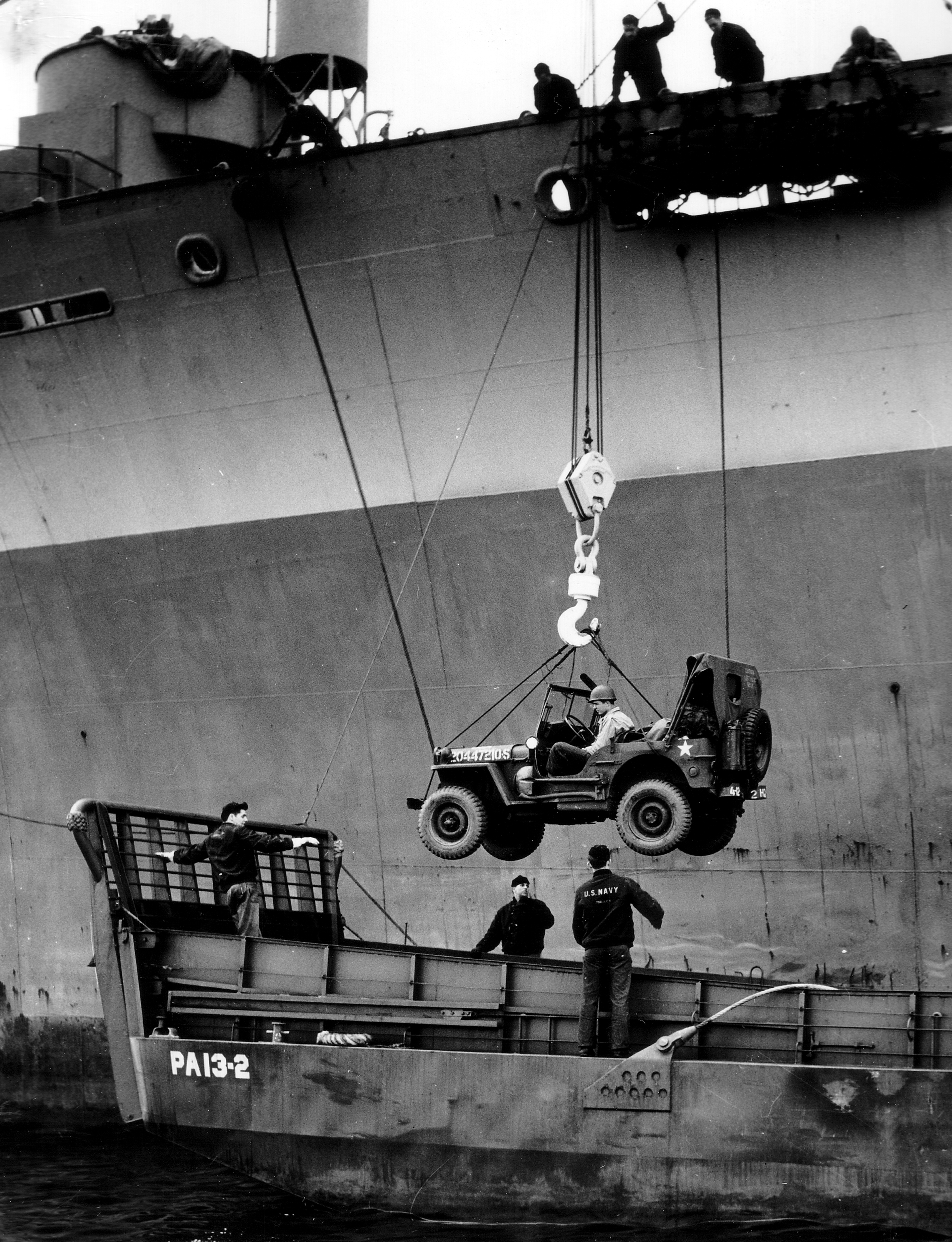 A Jeep being lowered into an LCM from Attack Transport USS Joseph T. Dickman (APA-13 – former SS President Roosevelt), manned by USCG personnel off Normandy, June 1944. Photo 1 of 2