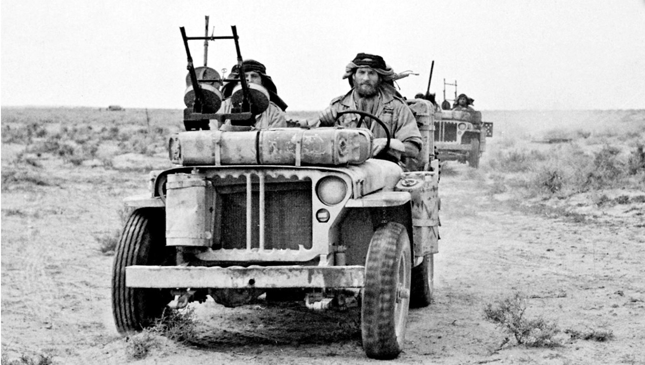 A close-up of a British heavily armed patrol of L Detachment SAS in their jeeps, just back from a three month patrol, 18 Jan 1943; note twin-mounted Vickers K machine guns; photo 3 of 3