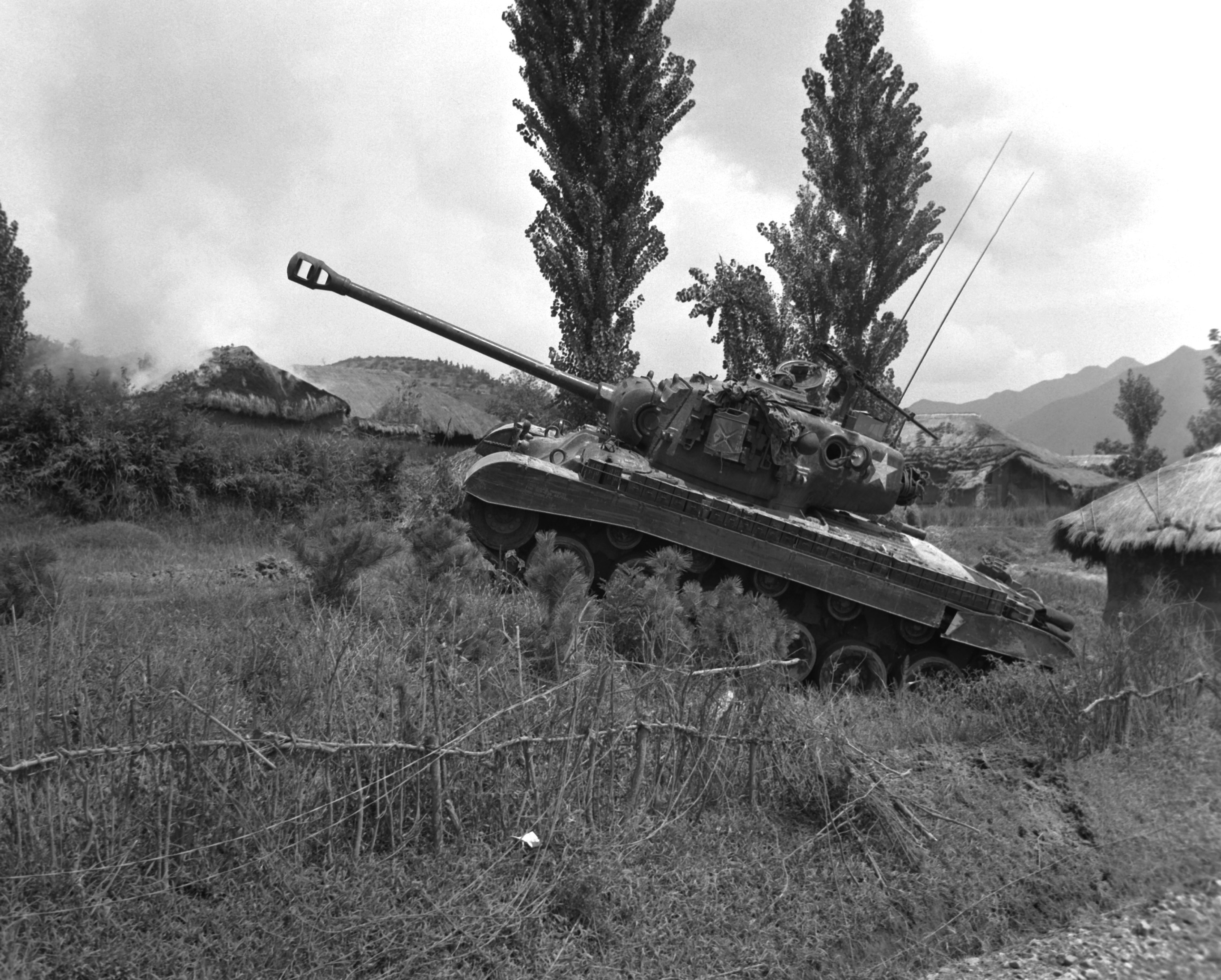 US Marine Corps Pershing tank at the edge of a village in Korea, 4 Sep 1950
