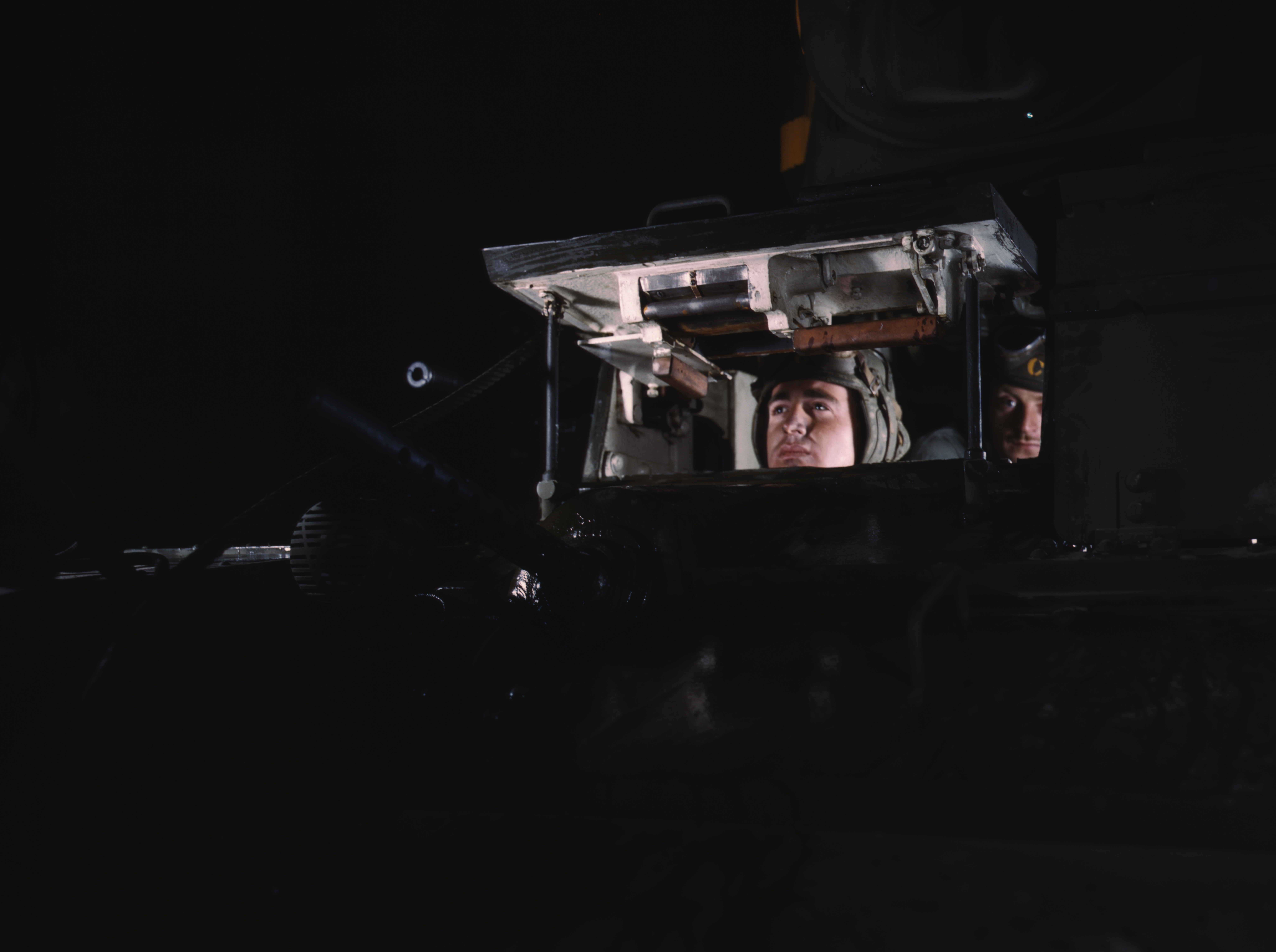 Crew of an American M2 light tank peering out of the forward hatch, Fort Knox, Kentucky, United States, Jun 1942