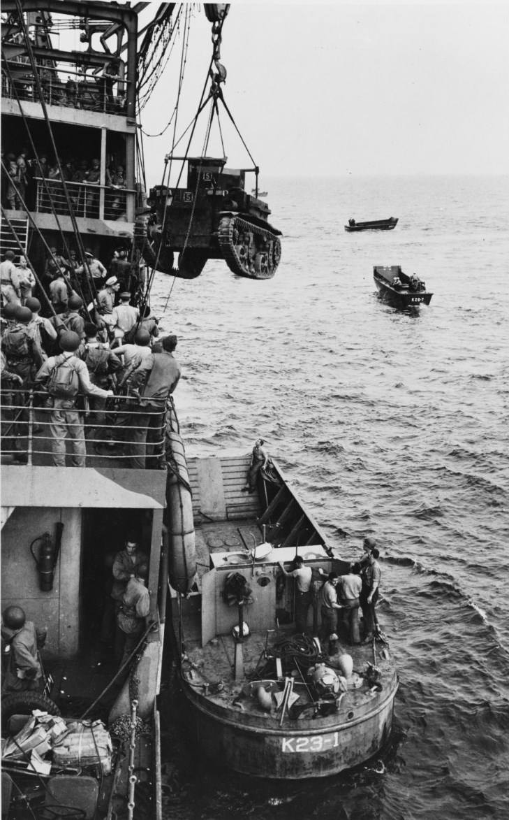 M2A4 Stuart tank being hoisted from USS Alchiba into a LCM(2) landing craft, off Guadalcanal, Solomon Islands, 7 Aug 1942