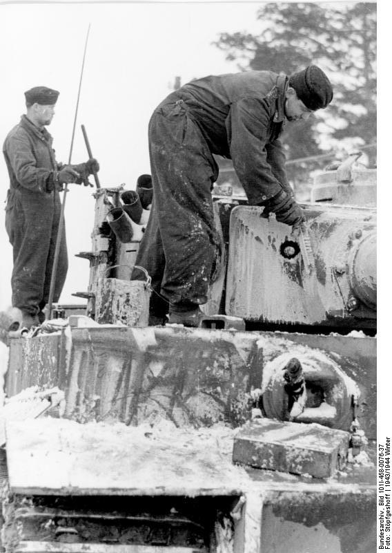 German tank crew paining their Tiger I heavy tank white for camouflage, Russia, winter of 1943-1944