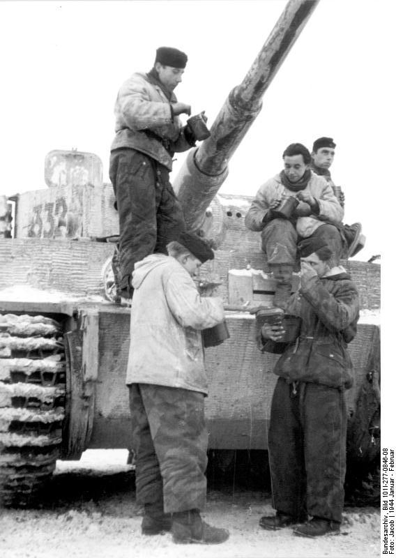 German tankers eating a meal by their winter-camouflaged Tiger I heavy tank, Russia, Jan-Feb 1944