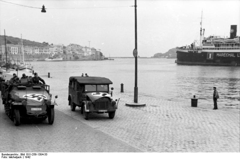 German SdKfz. 250 halftrack vehicle in a port in Southern France, 1942; note passenger ship Maréchal Lyautey in background