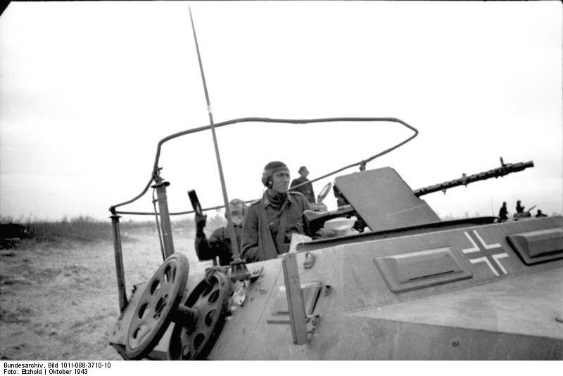 A German Luftwaffe Oberleutnant (Senior Lieutenant) performing air traffic control in the field in a specially-modified SdKfz. 251 vehicle, Russia, Oct 1943, photo 3 of 4; note MG34 machine gun