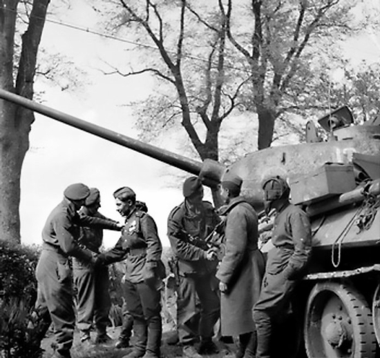 Men of the UK 6th Airborne Division greeting the crew of a Russian Army T-34/85 tank near Wismar, Mecklenburg-Vorpommern, Germany, 3 May 1945
