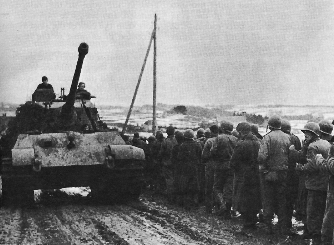 American prisoners of war being marched past a German Tiger II heavy tank, 1944