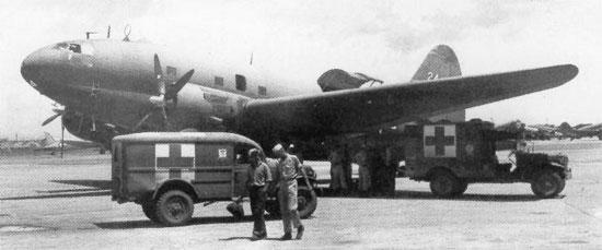 Dodge WC54 and WC64 KD 3/4-ton field ambulances standing by C-46 Commando aircraft at Clark Field, Manila, Philippine Islands, 29 Sep 1945