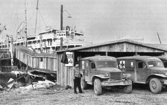 Covered ramp to waiting Hospital Ship, Leghorn, Italy; Dodge WC54 ambulances bringing patients for evacuation to Naples; fall 1944