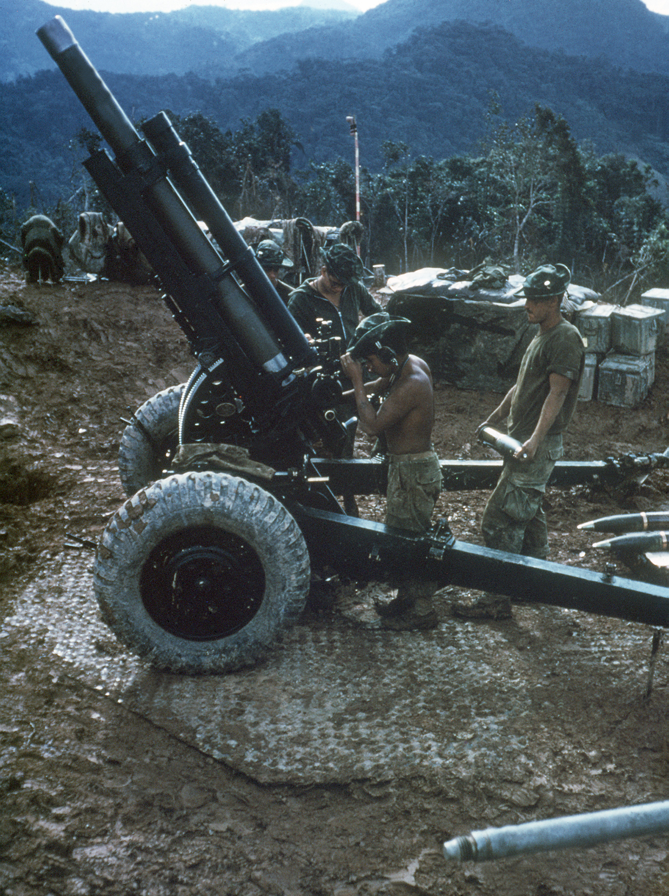 Men of US 3rd Marine Division preparing to load a round into their M101 105mm howitzer, Vietnam, 1 Jun 1968
