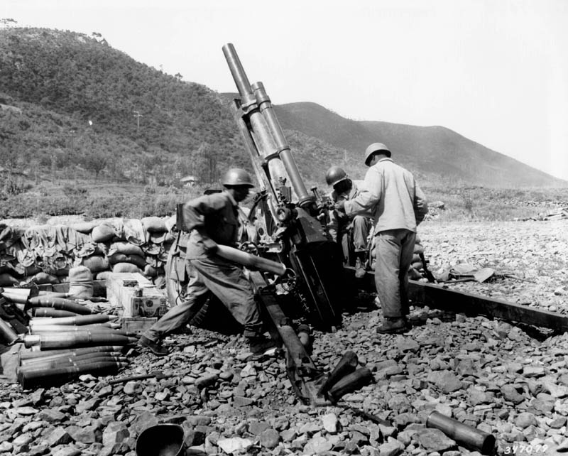 African-American 105mm Howitzer M2A1 crew of Battery A, US 159th Field Artillery Battalion firing their weapon near Uirson, Korea, 24 Aug 1950