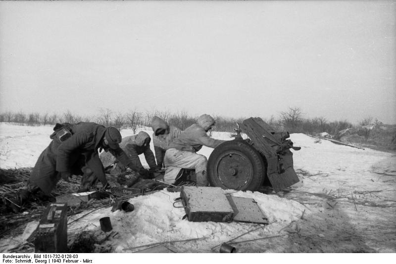 Troops of the German 'Großdeutschland' Division with 7.5 cm le.IG 18 field gun in a snowy field in Russia, Feb-Mar 1943