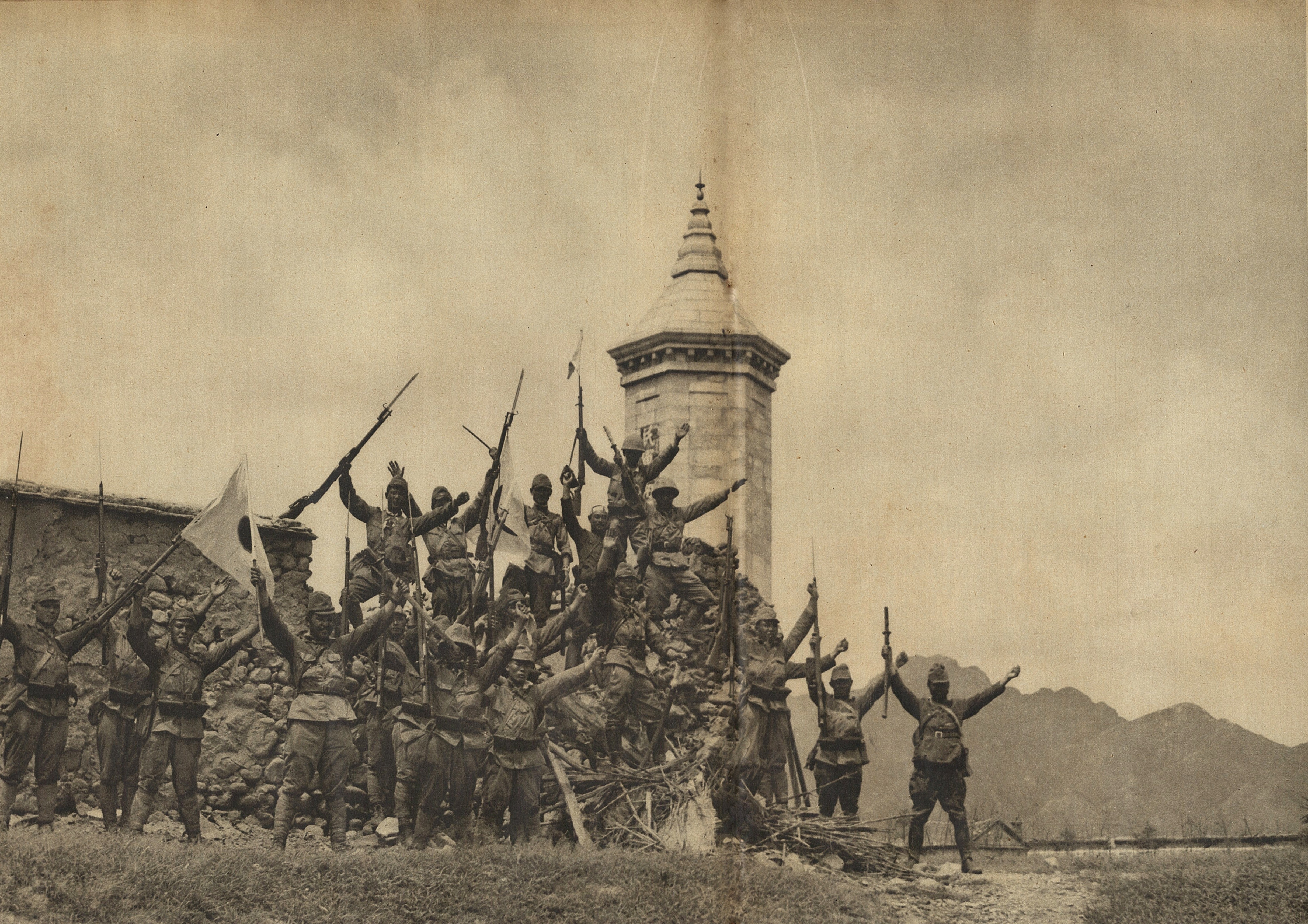 A group of Japanese Army officers and men cheering at Nankou, Beiping, China, 1937; seen in the 1 Sep 1937 issue of the Japanese publication Asahigraph