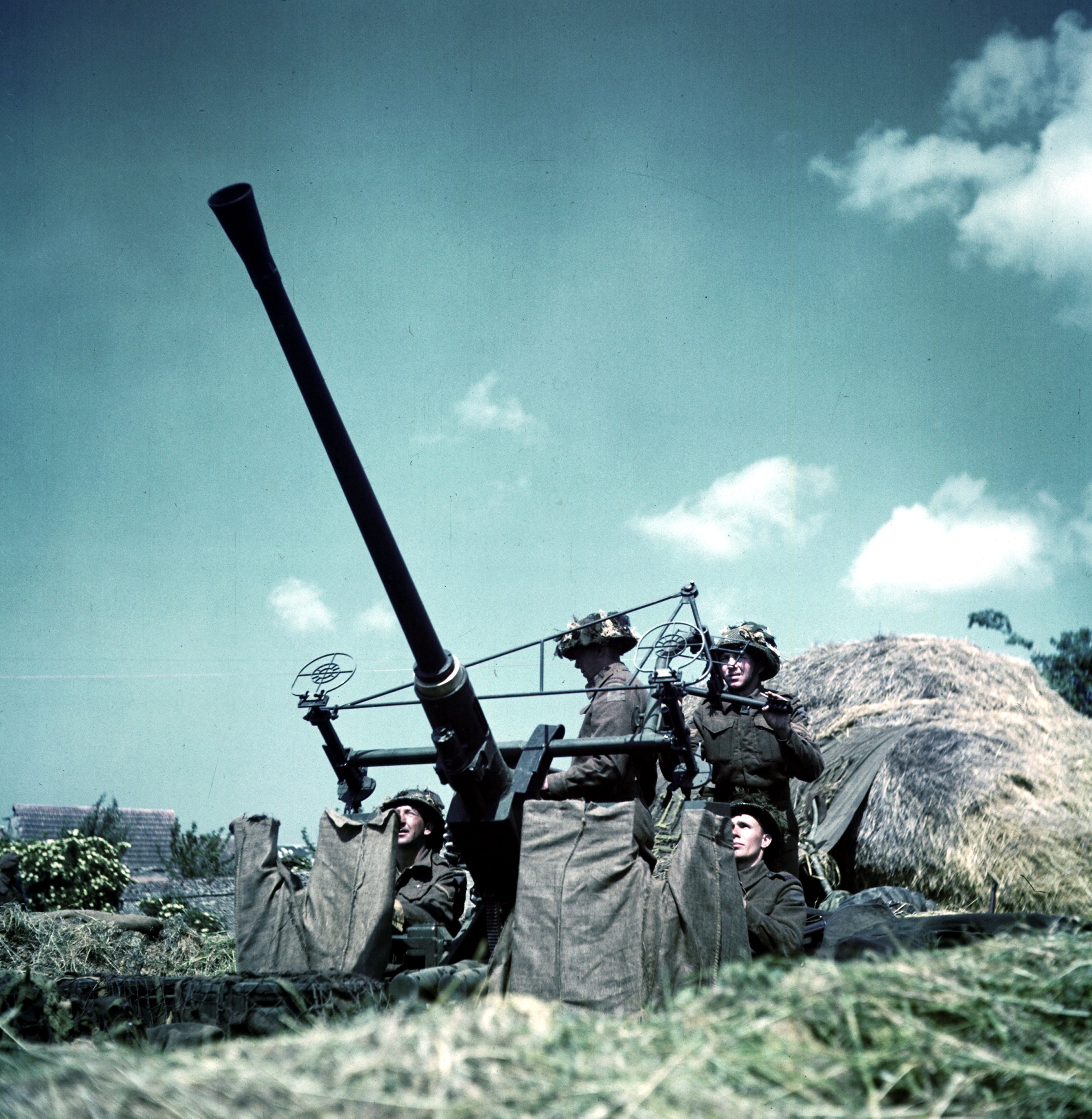 Canadian soldiers manning a 40-mm Bofors anti-aircraft gun in Normandy, France, Jun 1944