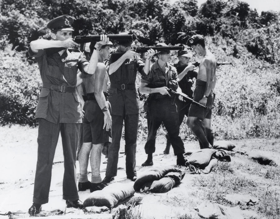 British General Gerald Templer test firing a De Lisle carbine, Perak, Malaya, 1952