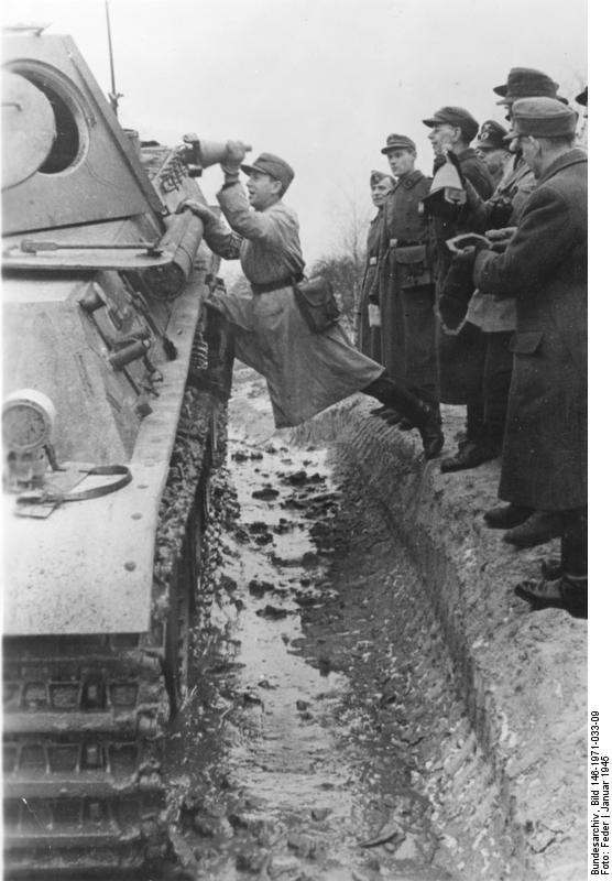 German soldier instructing Volkssturm militiamen on the use of 3 HL shaped charges on a Panther tank, Germany, Jan 1945