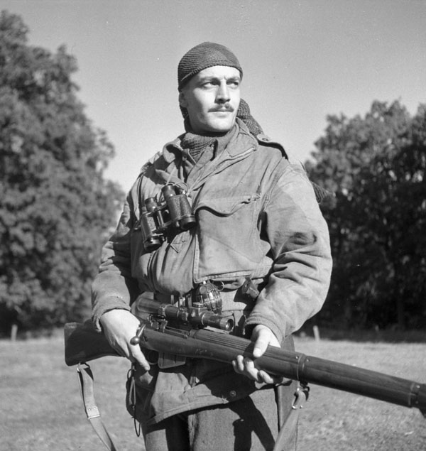 Canadian Calgary Highlanders Sniping Platoon Sergeant Harold A. Marshall posing with his Lee-Enfield No. 4 Mk. I rifle, Kapellen, Belgium, 6 Oct 1944