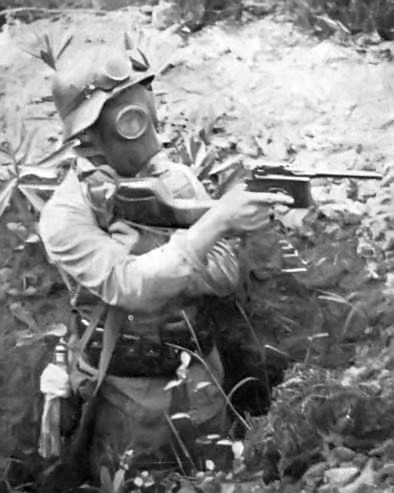 Nationalist Chinese Army soldier wearing a German-made/designed equipment (Stahlhelm, GM30 gas mask, Shansi Type 17 pistol), China, circa 1940s