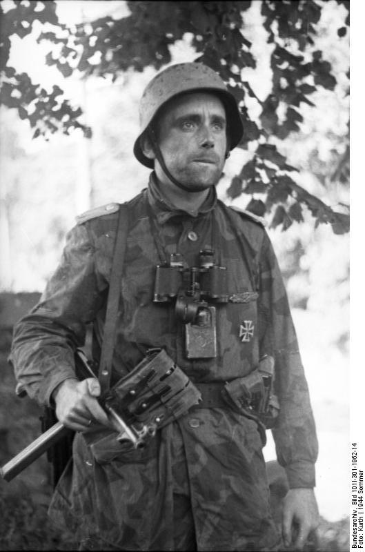 A German junior officer (Oberleutnant) with Iron Cross First Class medal and MP 40 submachine gun in northern France, Jul-Sep 1944