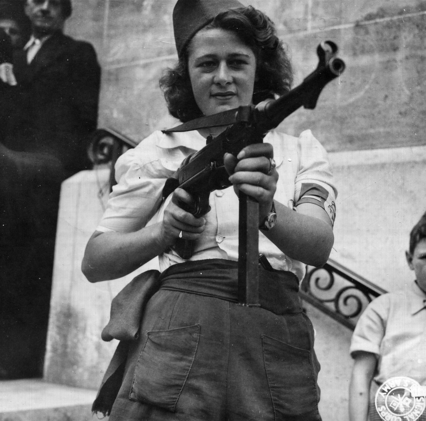Simone Segouin (nom de guerre Nicole Minet) posing with a MP 40 submachine gun, 23 Aug 1944