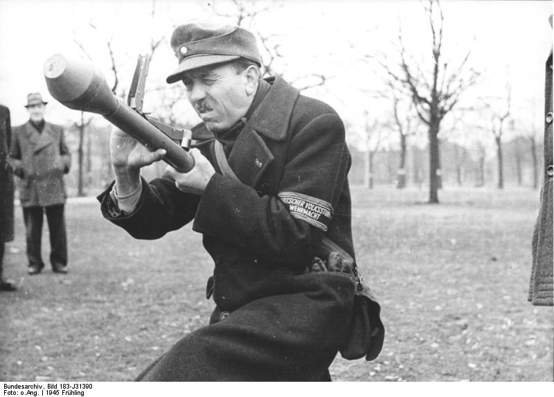 German Volkssturm soldier demonstrating how to use a Panzerfaust, Berlin, Germany, spring 1945